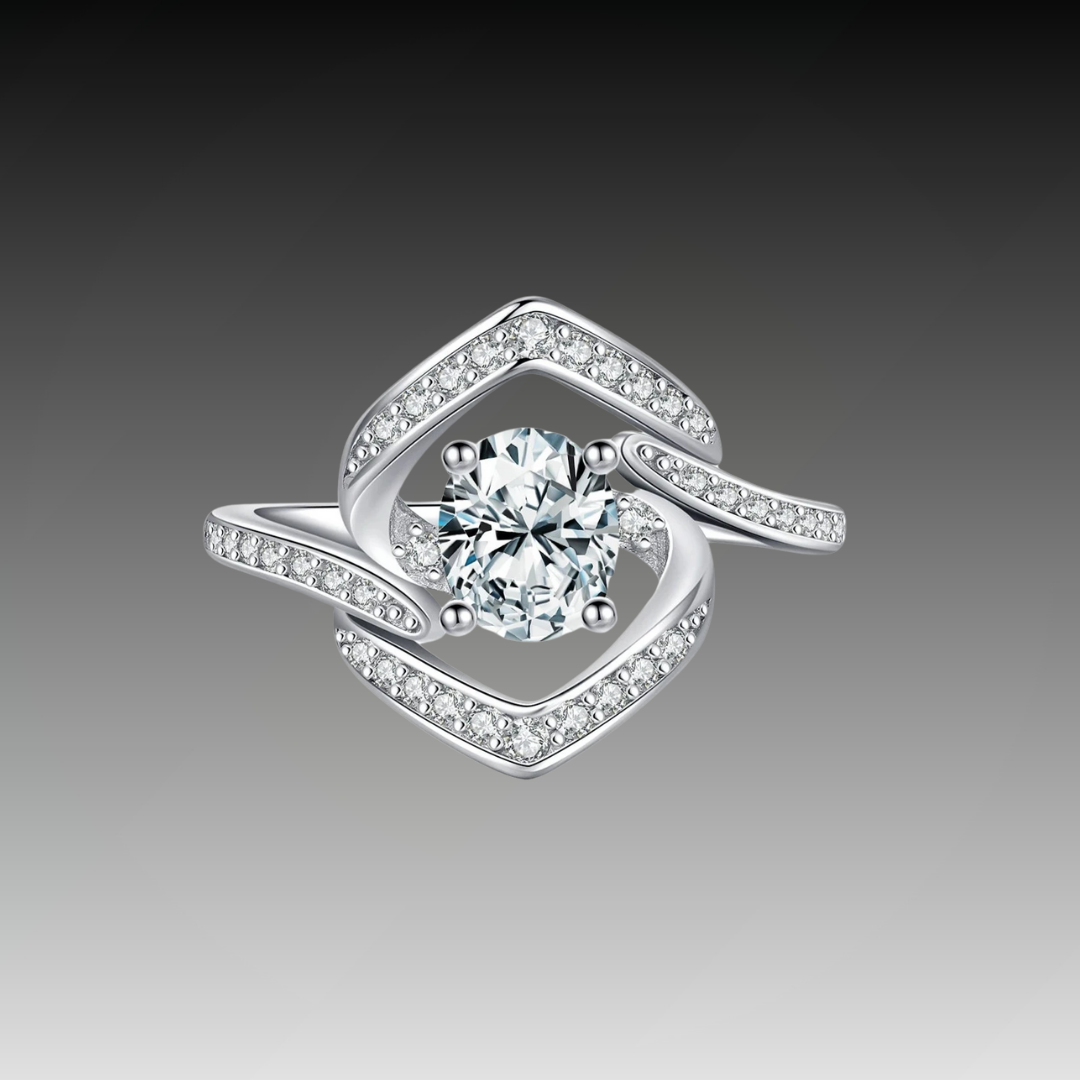 Silver ring with a central round white stone encircled by two asymmetrical open square-shaped bands encrusted with smaller stones.


