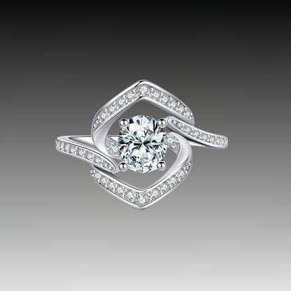 Silver ring with a central round white stone encircled by two asymmetrical open square-shaped bands encrusted with smaller stones.

