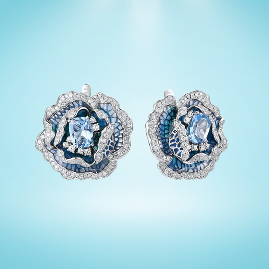 Silver and blue enamel rose-shaped earrings with layered petals and central light blue gemstones

