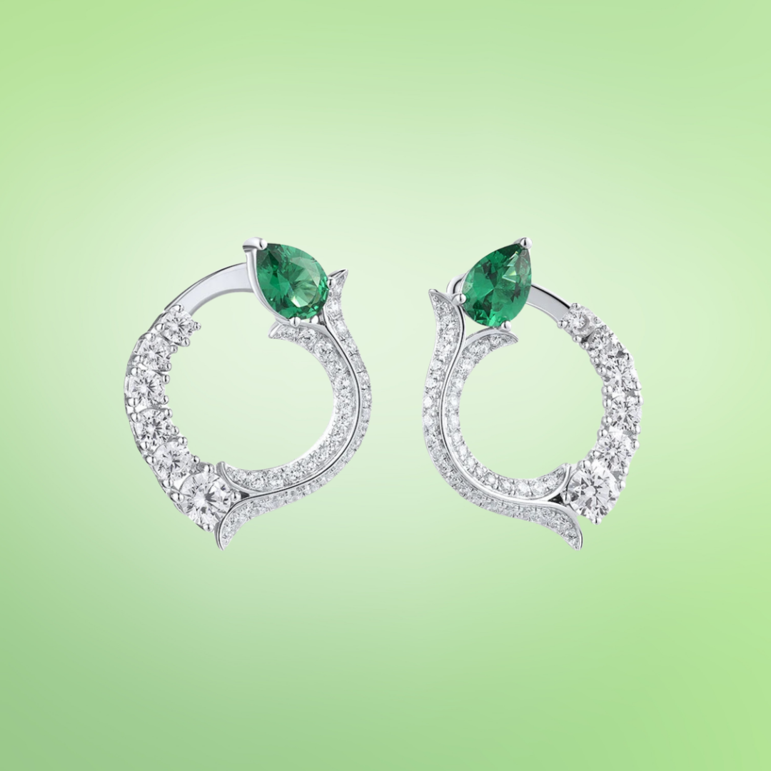 Silver earrings with circular diamond pave design and pear-shaped green jade stones at the top

