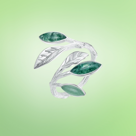Adjustable silver ring featuring green marbled leaf accents in an open branch design.

