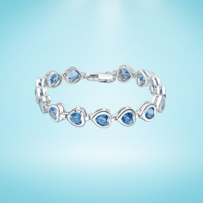 Silver bracelet with heart-shaped blue stones in a linked design


