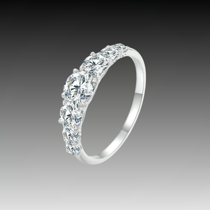 Silver band ring adorned with a sequence of round brilliant-cut stones, creating a continuous sparkling design.


