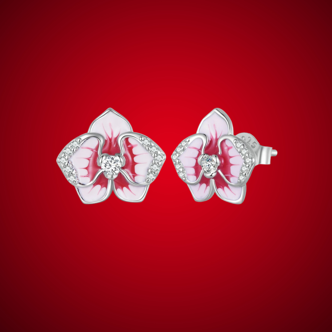 Silver orchid-shaped stud earrings with red and white enamel petals and central white stones

