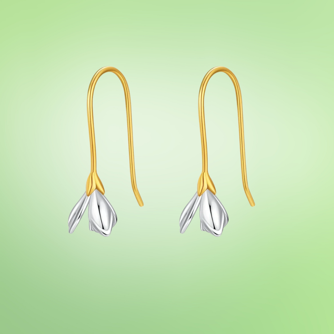Gold hook earrings with delicate silver flower bud drops.

