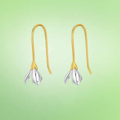 Gold hook earrings with delicate silver flower bud drops.

