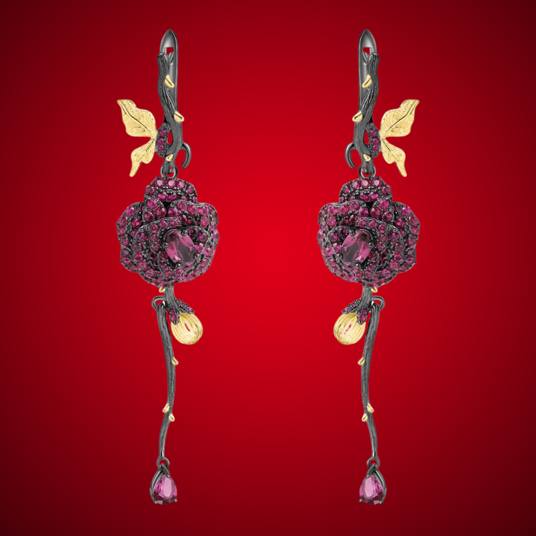 Long black rose earrings with red gemstones, gold leaves, and bud details from the Rossa Collection.


