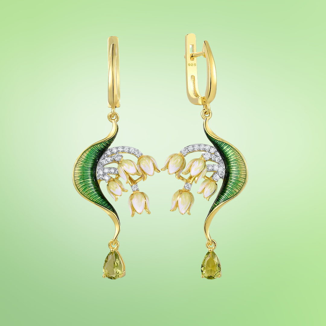 Gold drop earrings with curved green enamel leaves and cascading pink floral buds accented by pavé stones and teardrop gems

