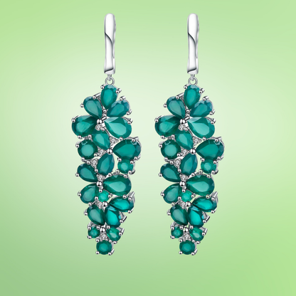 Dangling silver earrings with clustered green teardrop stones arranged in a cascading floral pattern


