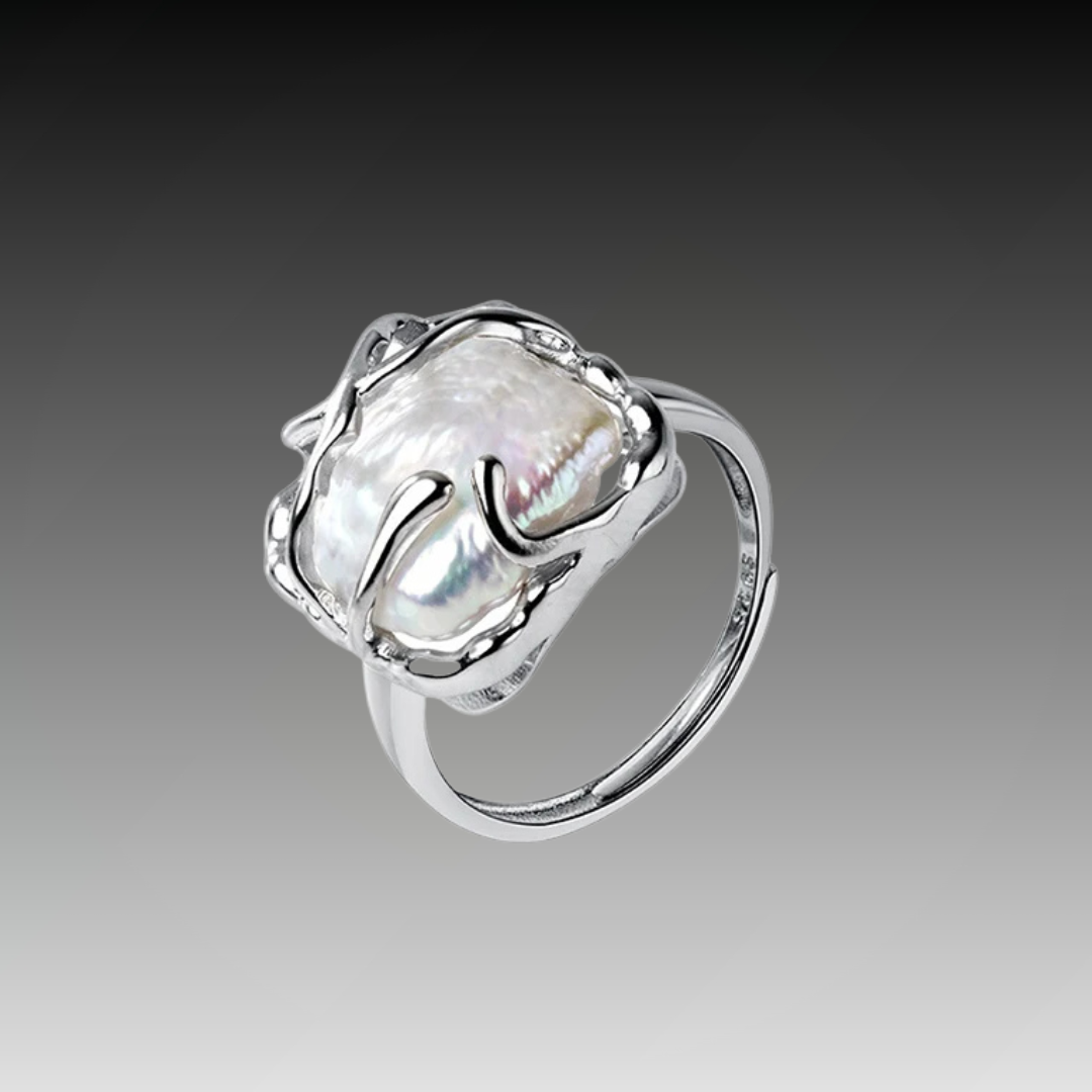 Sterling silver ring featuring a baroque freshwater pearl encased in an abstract organic claw setting

