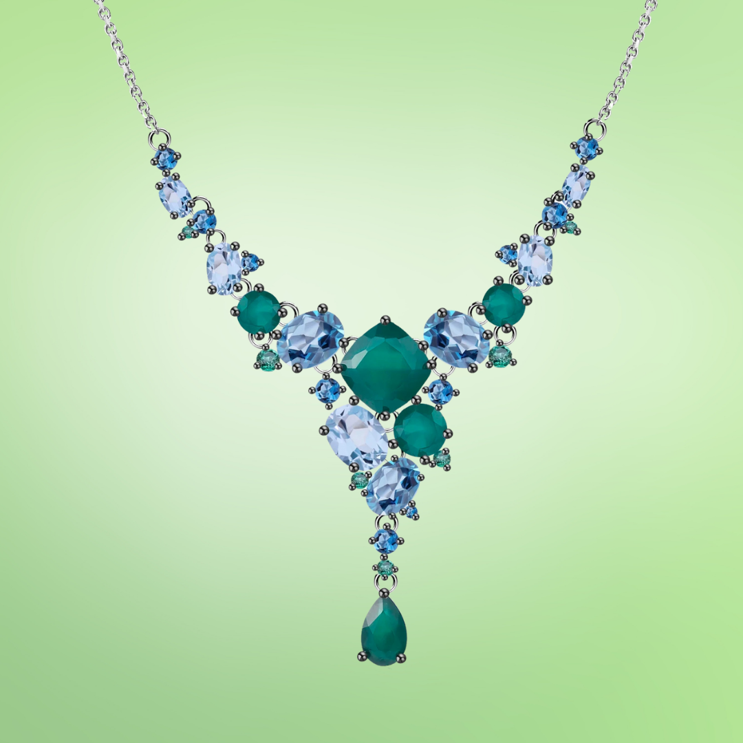 Statement necklace with green and blue gemstones arranged in a cascading natural pattern

