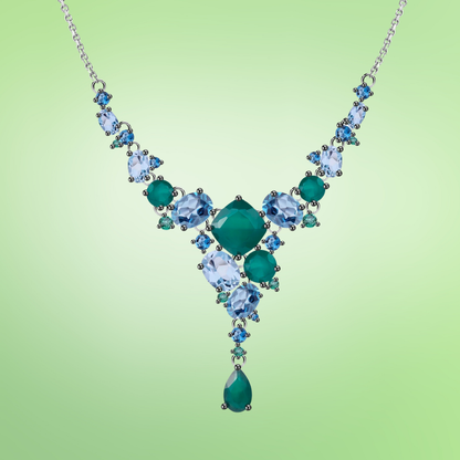Statement necklace with green and blue gemstones arranged in a cascading natural pattern

