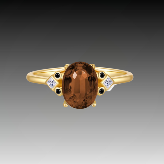 Gold ring with large oval brown gemstone and black and white accent stones

