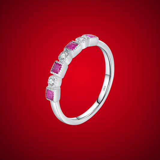 Sterling silver ring with alternating square-cut red stones and round clear stones in a linear setting.

