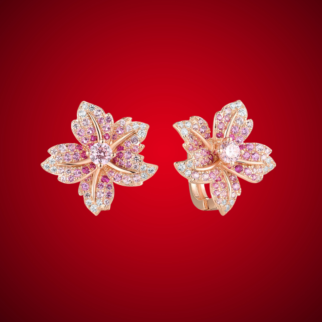 Rose gold floral earrings shaped like lilies, adorned with pink and clear pavé stones.

