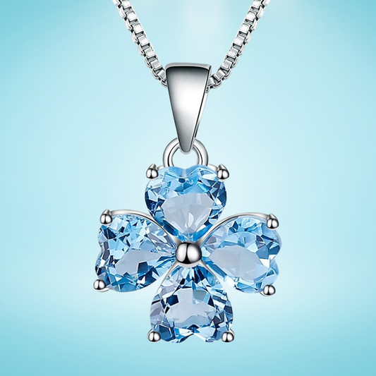 Silver pendant featuring four heart-cut light blue stones arranged in a floral shape

