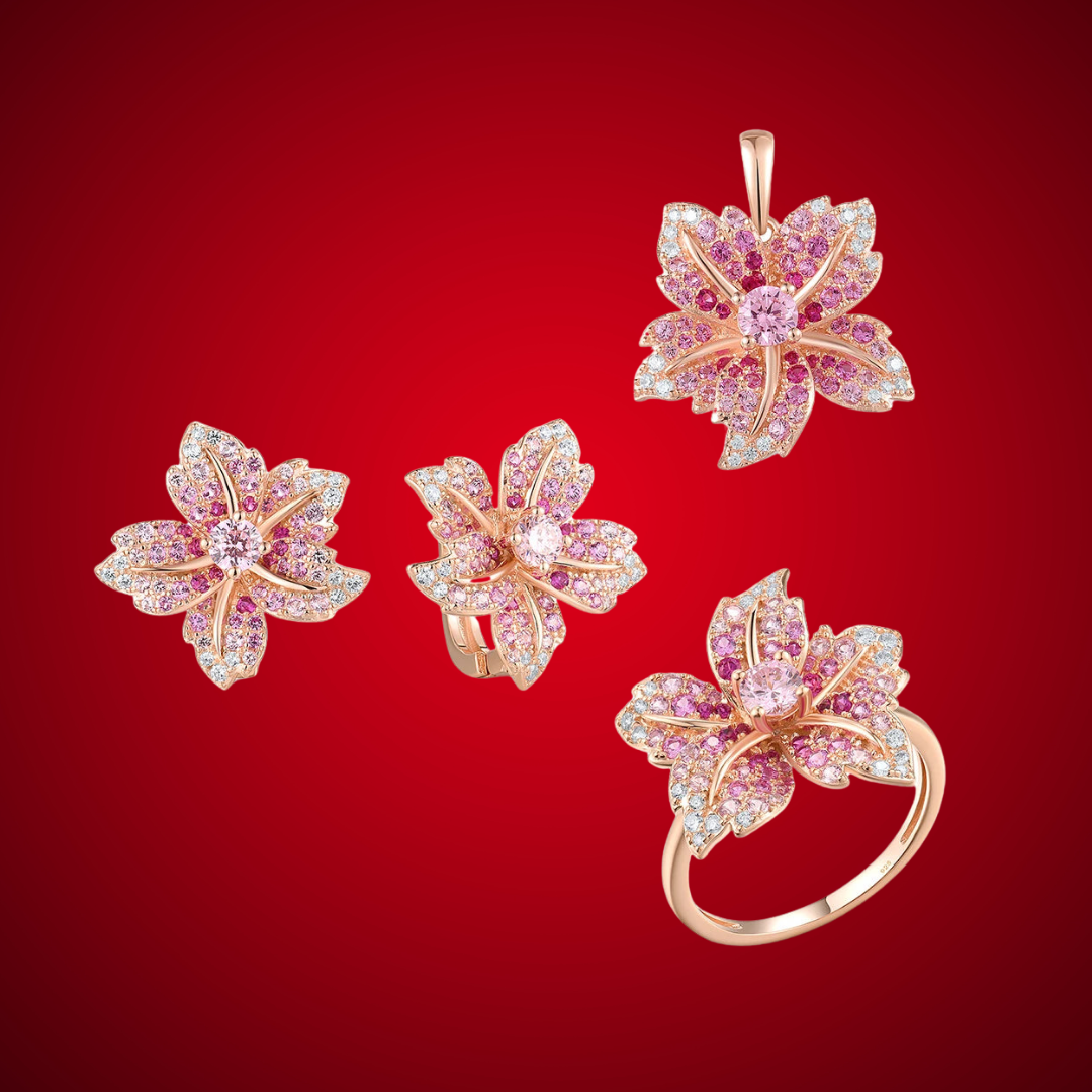 Giglio Rosa jewelry set featuring flower-shaped rose gold pieces with pink and white pavé stones, including ring, earrings, and pendant.

