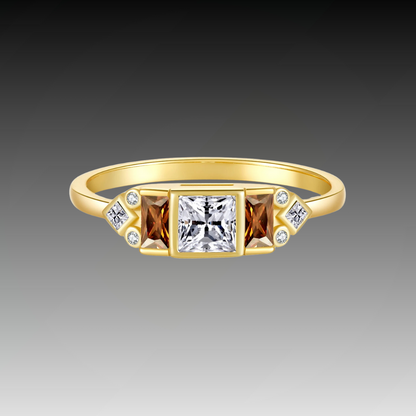 Gold ring with central white stone flanked by smoky square-cut stones and small accent gems


