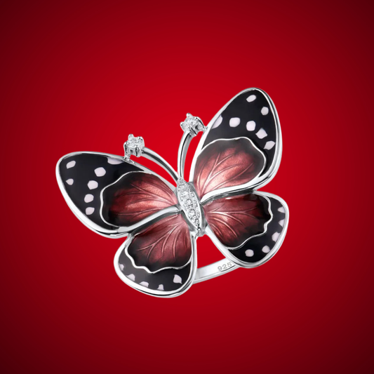 Statement ring shaped like a butterfly, with enamelled black and deep red wings and crystal detailing on the body.

