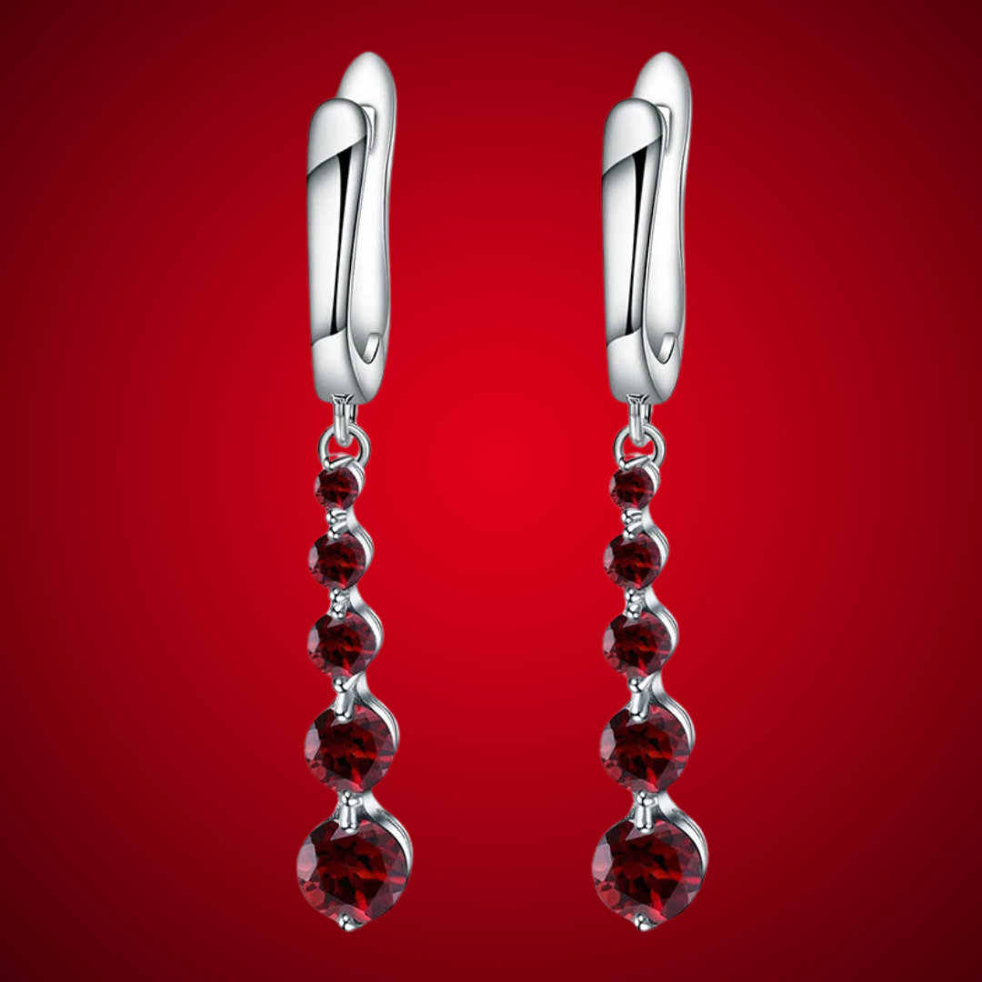 Silver drop earrings featuring a vertical cascade of five round garnet-red stones, from the Rossa Collection.

