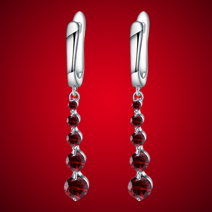 Silver drop earrings featuring a vertical cascade of five round garnet-red stones, from the Rossa Collection.

