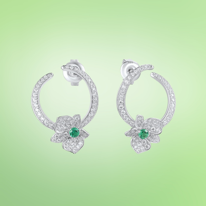 Silver stud earrings with open circle design, pavé stones, and green gemstone floral accents


