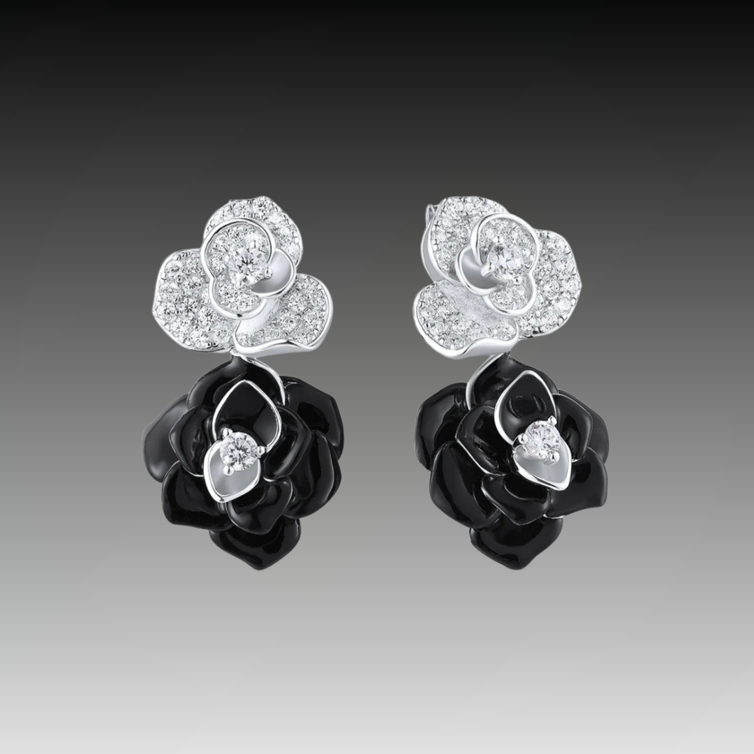 Silver and black enamel earrings shaped like layered roses with pavé accents

