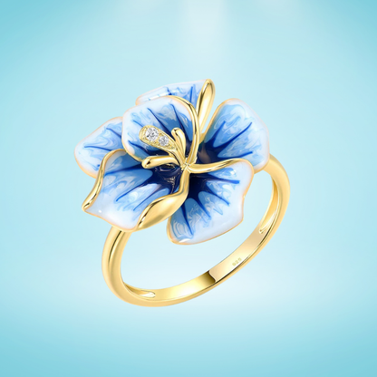 Gold-plated ring with hand-painted blue and white enamel flower and crystal accents

