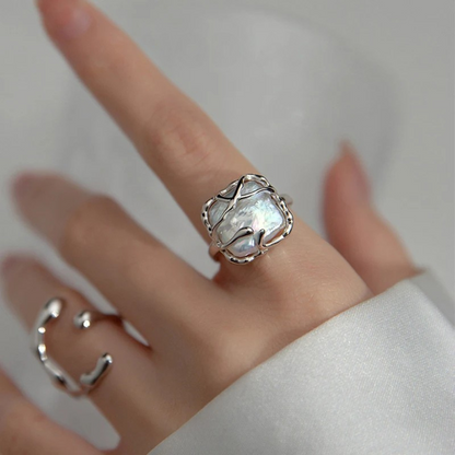 Sterling silver ring featuring a baroque freshwater pearl encased in an abstract organic claw setting

