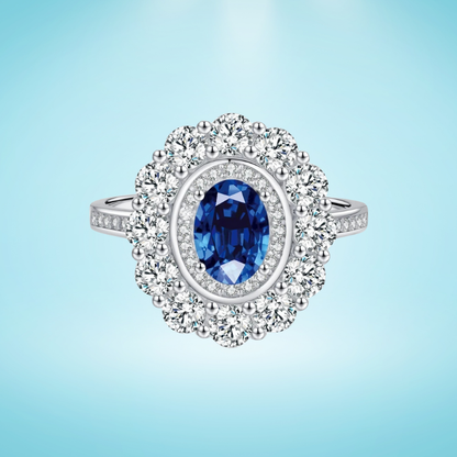 Silver ring with an oval deep blue stone surrounded by two halos of clear zirconia stones