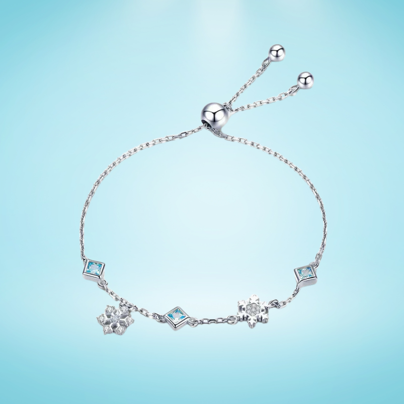 Delicate silver adjustable bracelet with blue square-cut stones and snowflake charms

