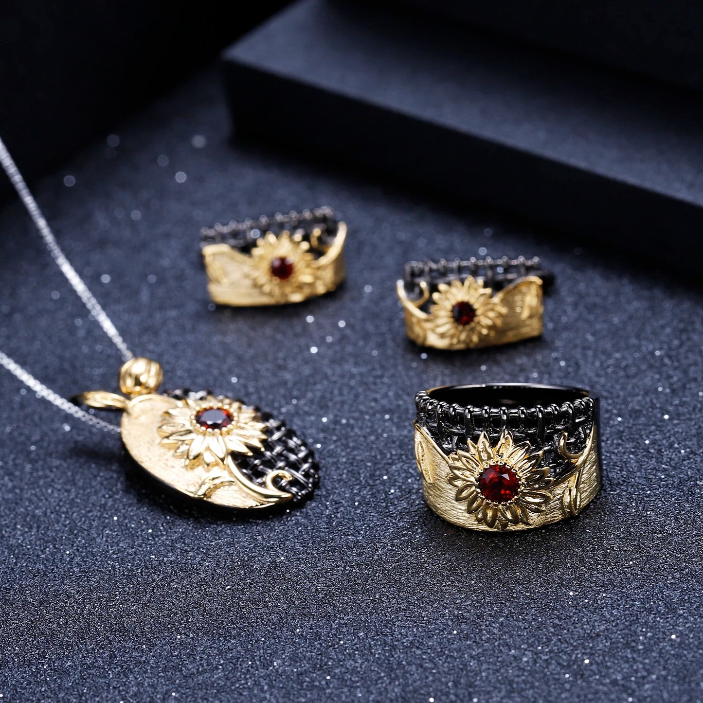 Coordinated necklace, earrings, and ring set with gold sunflower design and purple gemstones


