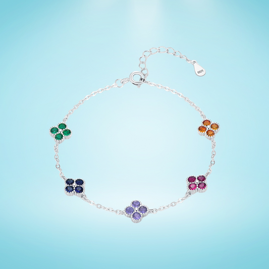 Silver bracelet with multicoloured gemstone clusters in floral shapes.

