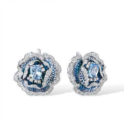 Silver and blue enamel rose-shaped earrings with layered petals and central light blue gemstones

