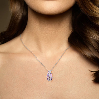Ring featuring overlapping pavé crystal bands over clustered purple and pink gemstones in various cuts.

