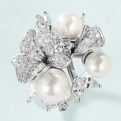 Jewellery set with white pearls and pavé floral details including earrings, brooch and pendant

