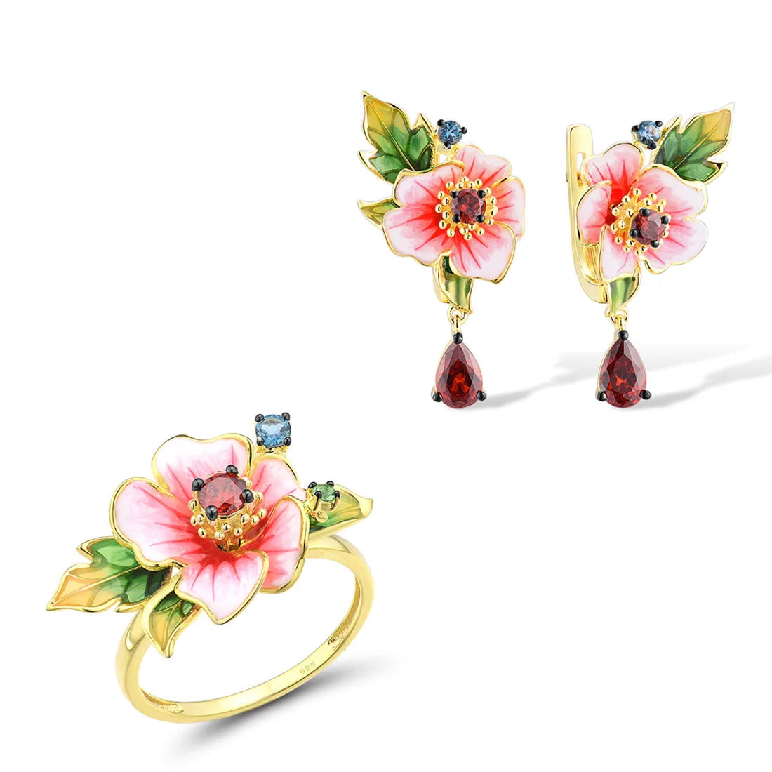 Amaryllis jewelry set with pink enamel flowers, red teardrop stones, green leaf accents, and small blue gemstones on a gold base.


