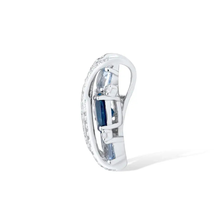 Sterling silver jewelry piece featuring crisscross pavé bands over clustered light and dark blue gemstones