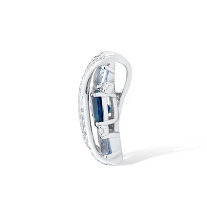 Sterling silver jewelry piece featuring crisscross pavé bands over clustered light and dark blue gemstones