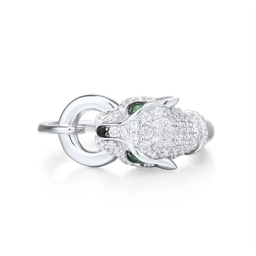 Silver ring featuring a panther head with green gemstone eyes and pavé detailing

