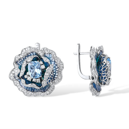 Silver and blue enamel rose-shaped earrings with layered petals and central light blue gemstones

