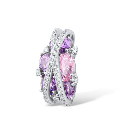 Ring featuring overlapping pavé crystal bands over clustered purple and pink gemstones in various cuts.

