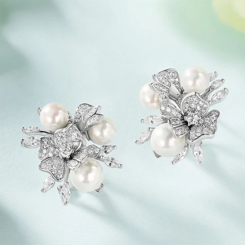 Jewellery set with white pearls and pavé floral details including earrings, brooch and pendant

