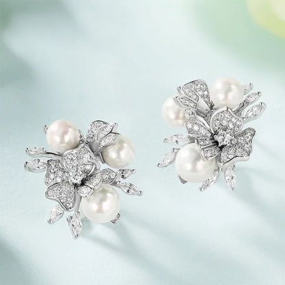 Jewellery set with white pearls and pavé floral details including earrings, brooch and pendant

