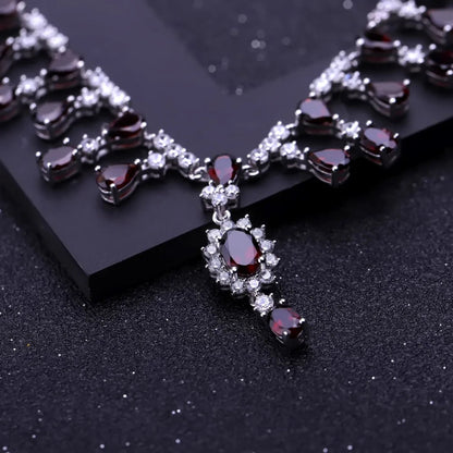 Necklace with red gemstones and clear stones on a black background