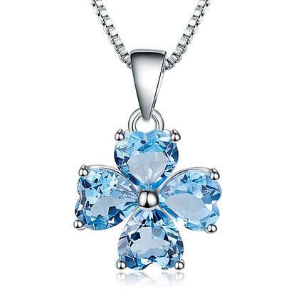 Silver pendant featuring four heart-cut light blue stones arranged in a floral shape

