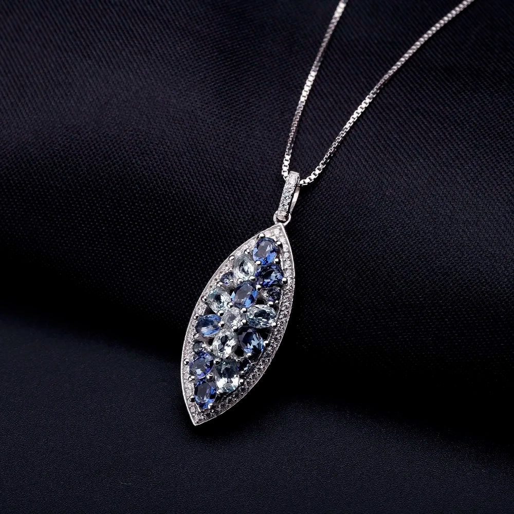 Marquise-shaped silver pendant with a floral arrangement of light and dark blue gemstones

