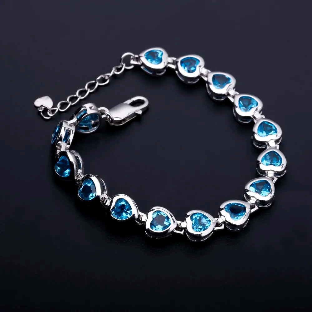 Silver bracelet with heart-shaped blue stones in a linked design

