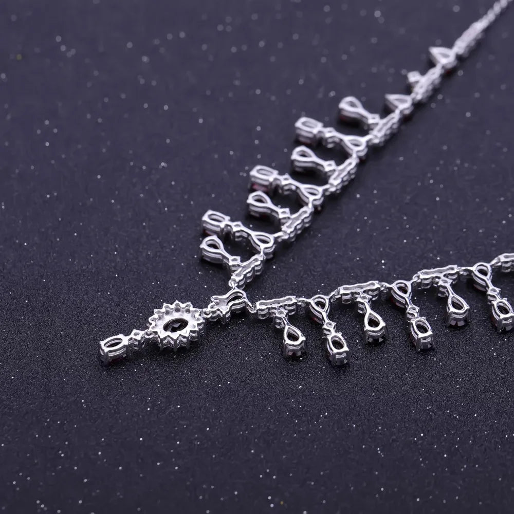 Necklace with red gemstones and clear stones on a black background