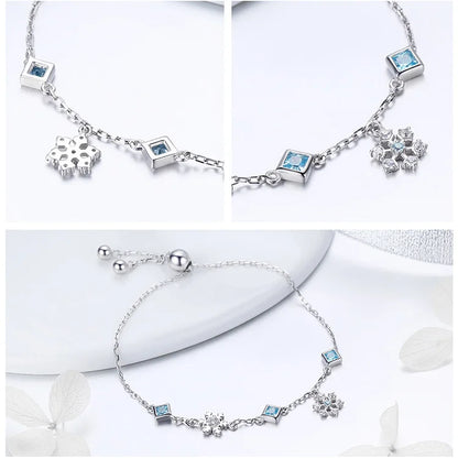 Delicate silver adjustable bracelet with blue square-cut stones and snowflake charms

